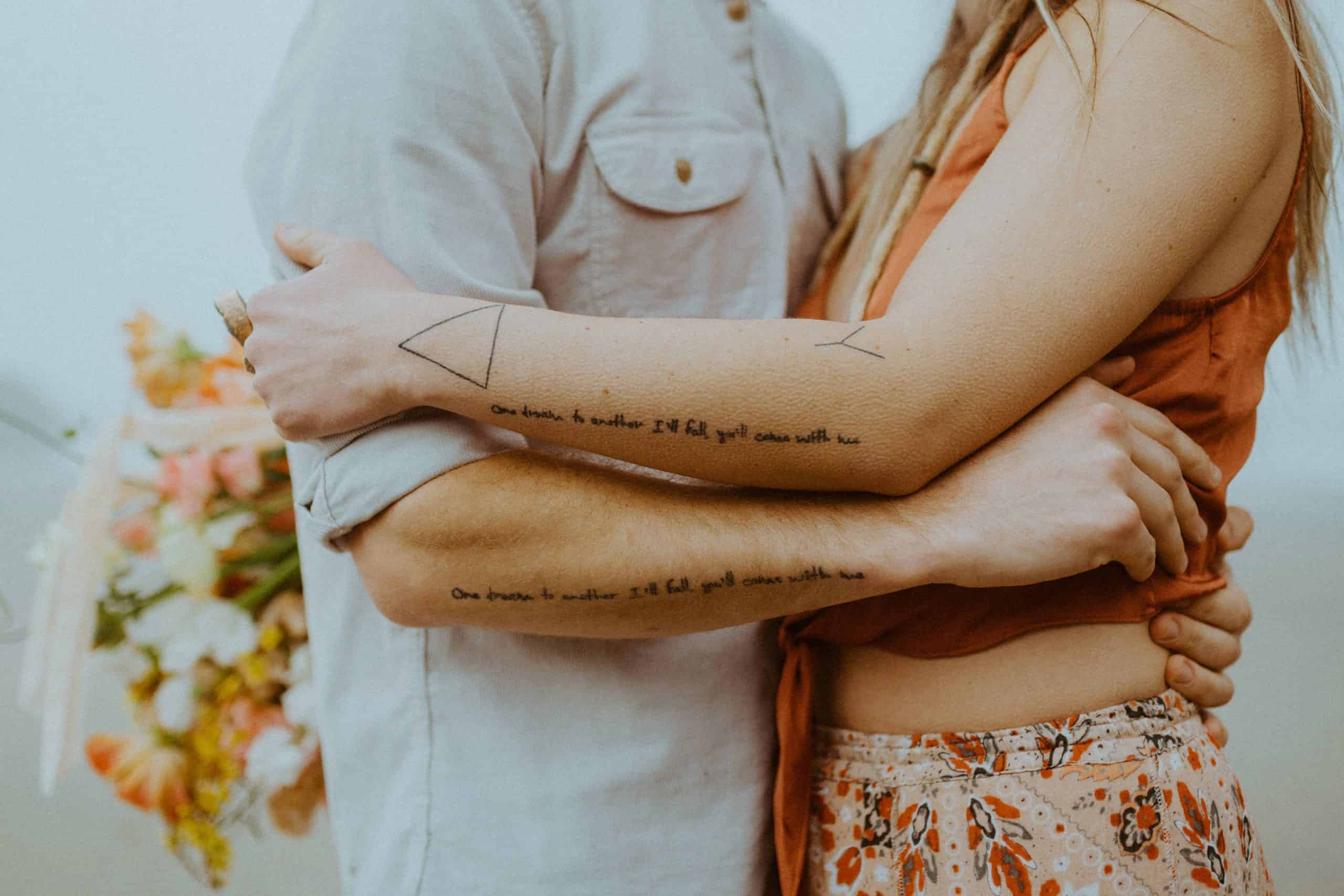 close up of couples matching tattoos