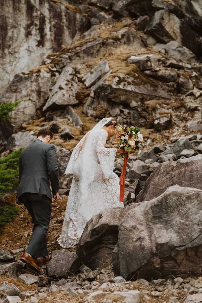 adventure elopement couple hikes up Iceland mountainside with bouquet