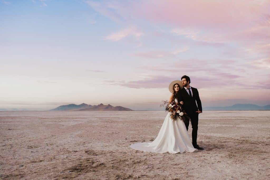 bride and groom stand side by side at the Bonneville Salt Flats in Utah