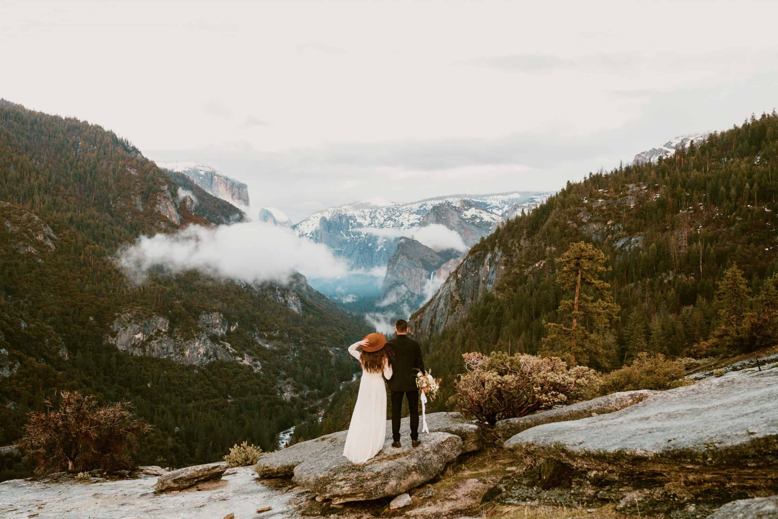 bride and groom look out into Yosemite National Park