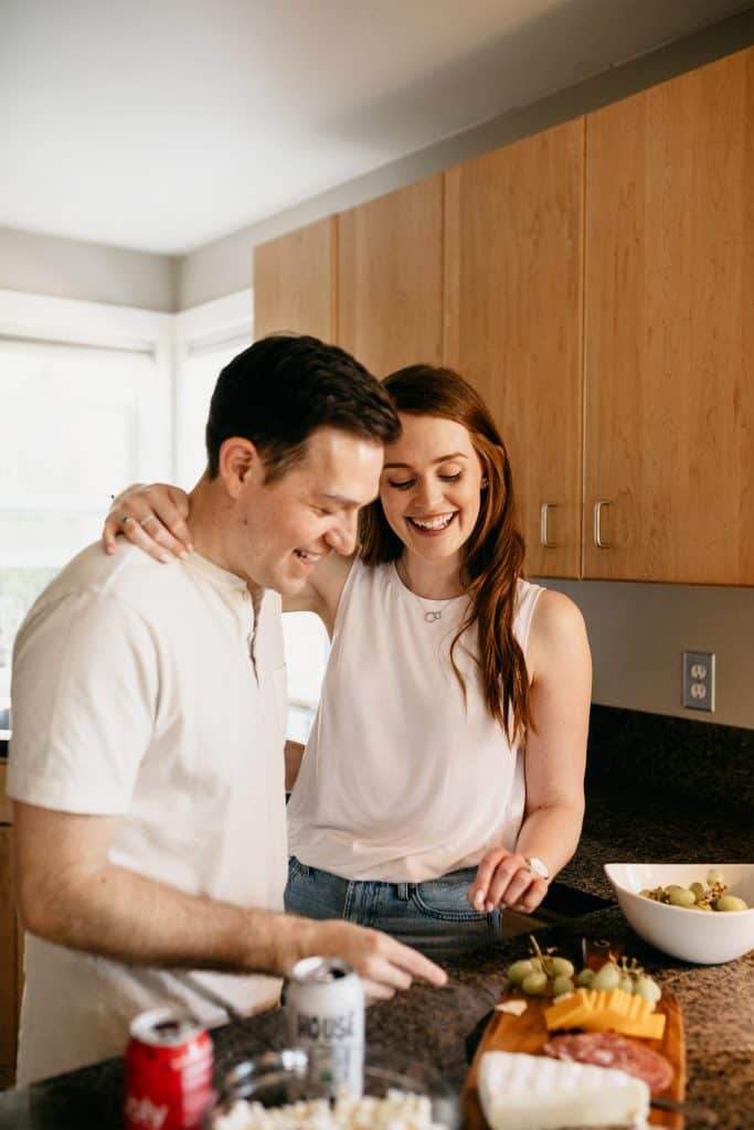 boyfriend and girlfriend stay inside and make dinner for an at-home date night activity