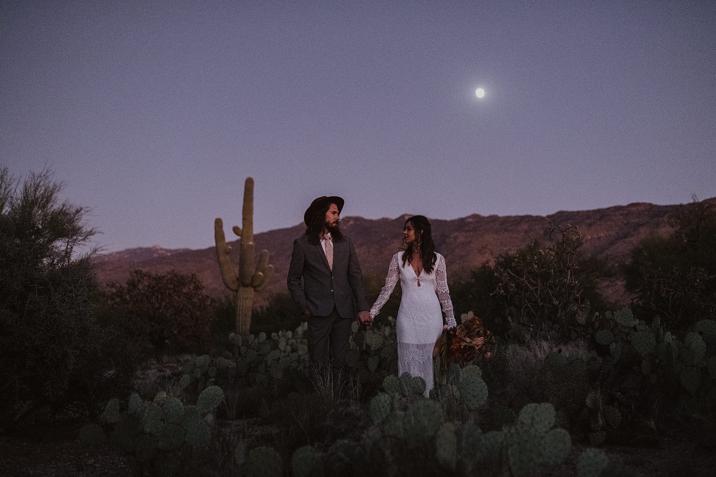 couple standing together at saguaro national park during the evening 