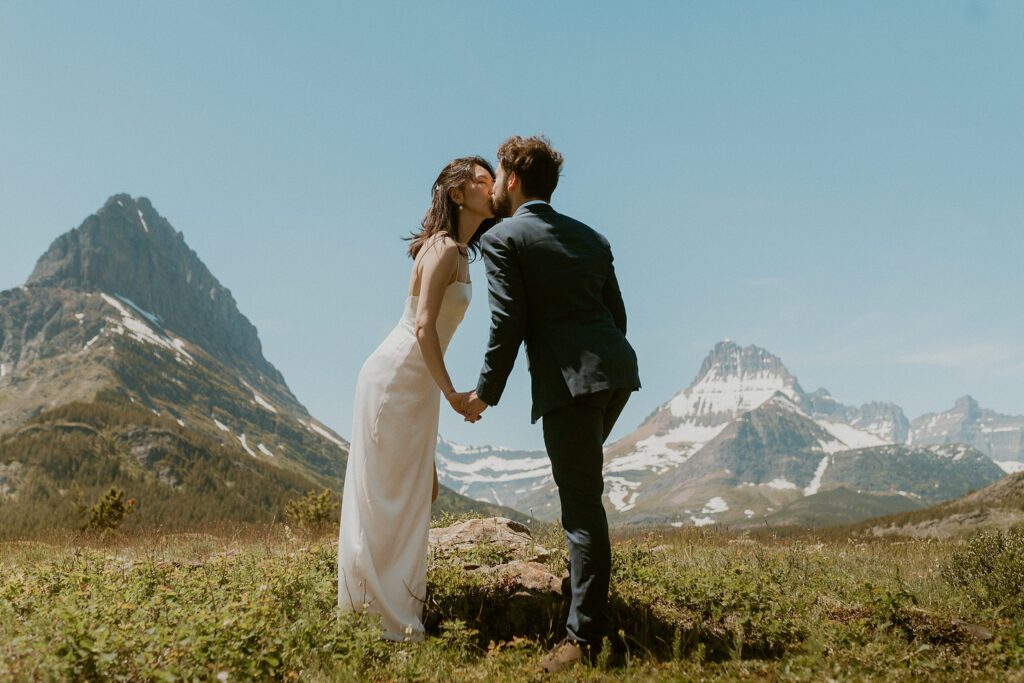 couple kissing mountain landscape background