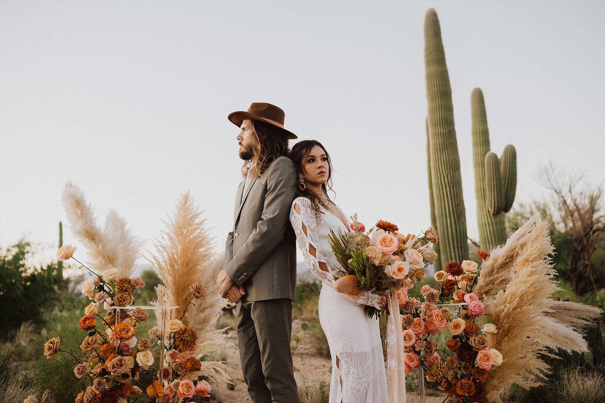 bride and groom standing together desert landscape

 