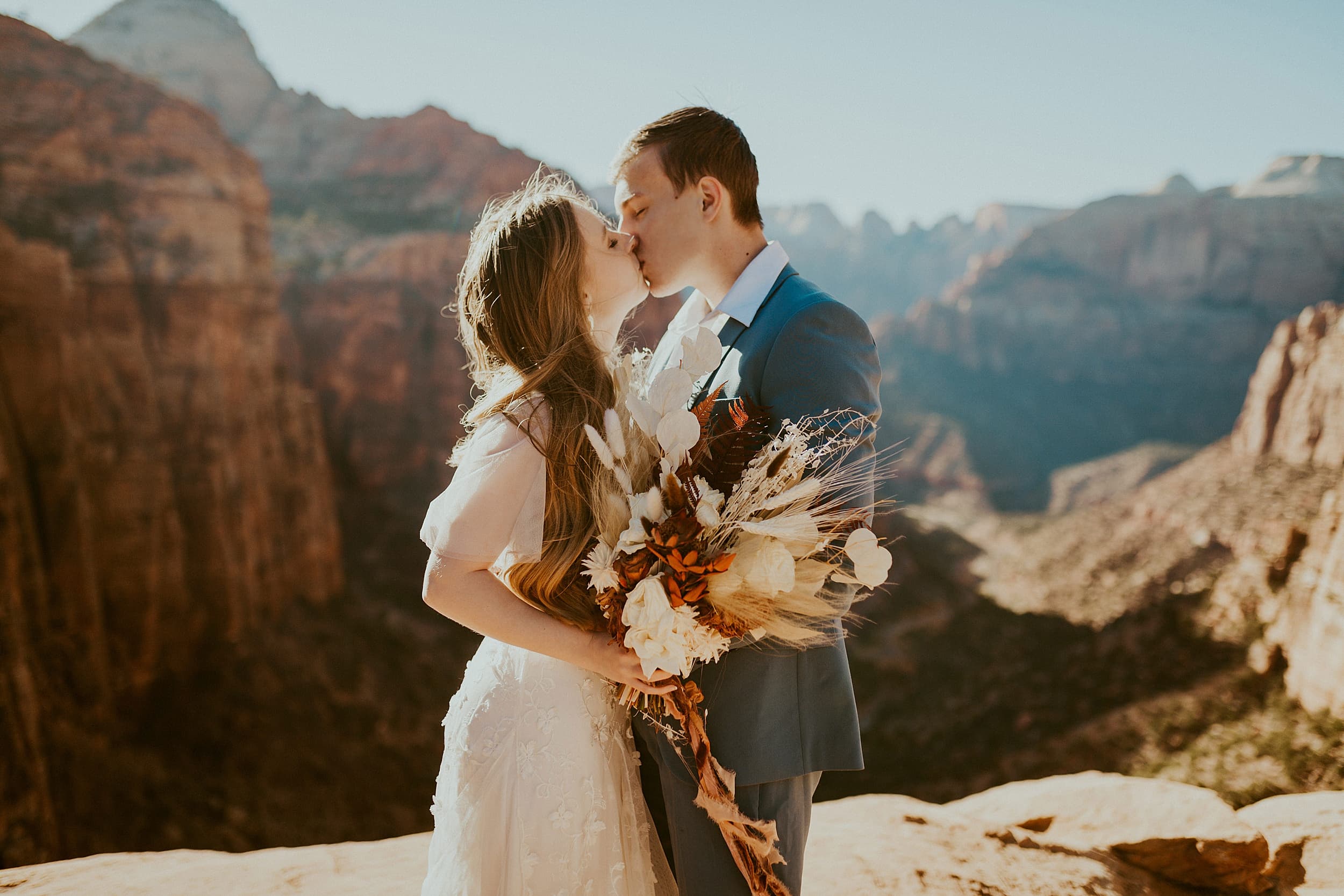 bride and groom kissing zion national park 

