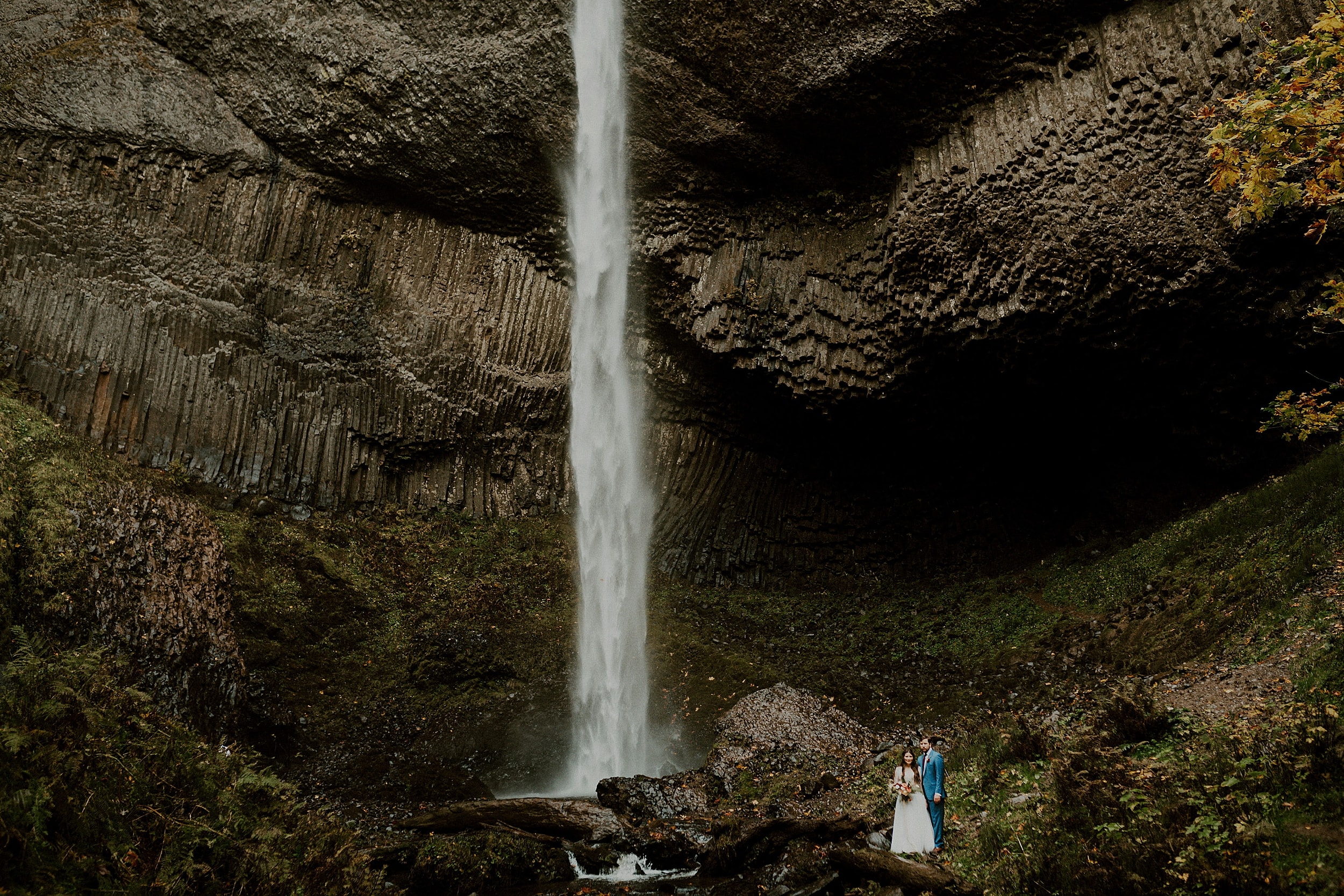 bride and groom standing together latourell falls landscape