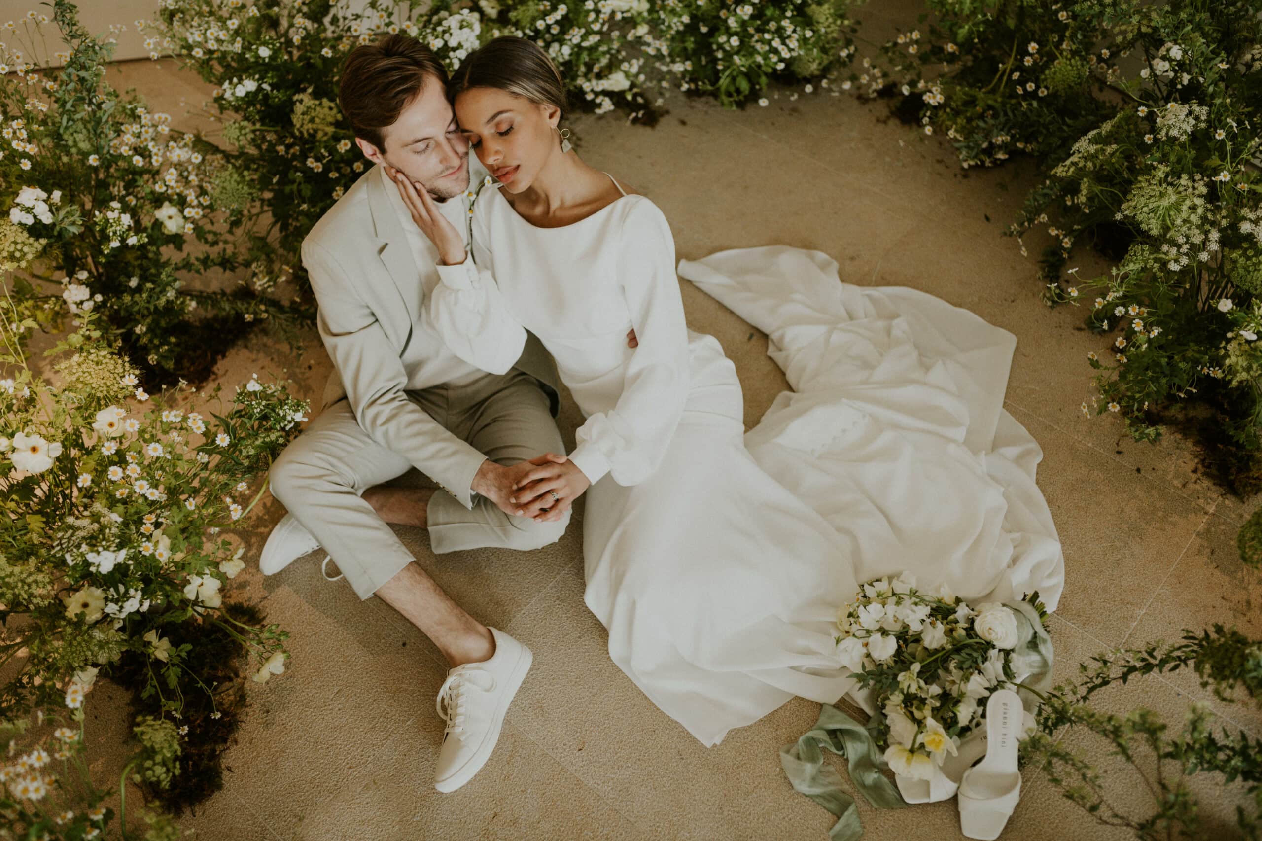 couple laying together surrounded by flowers