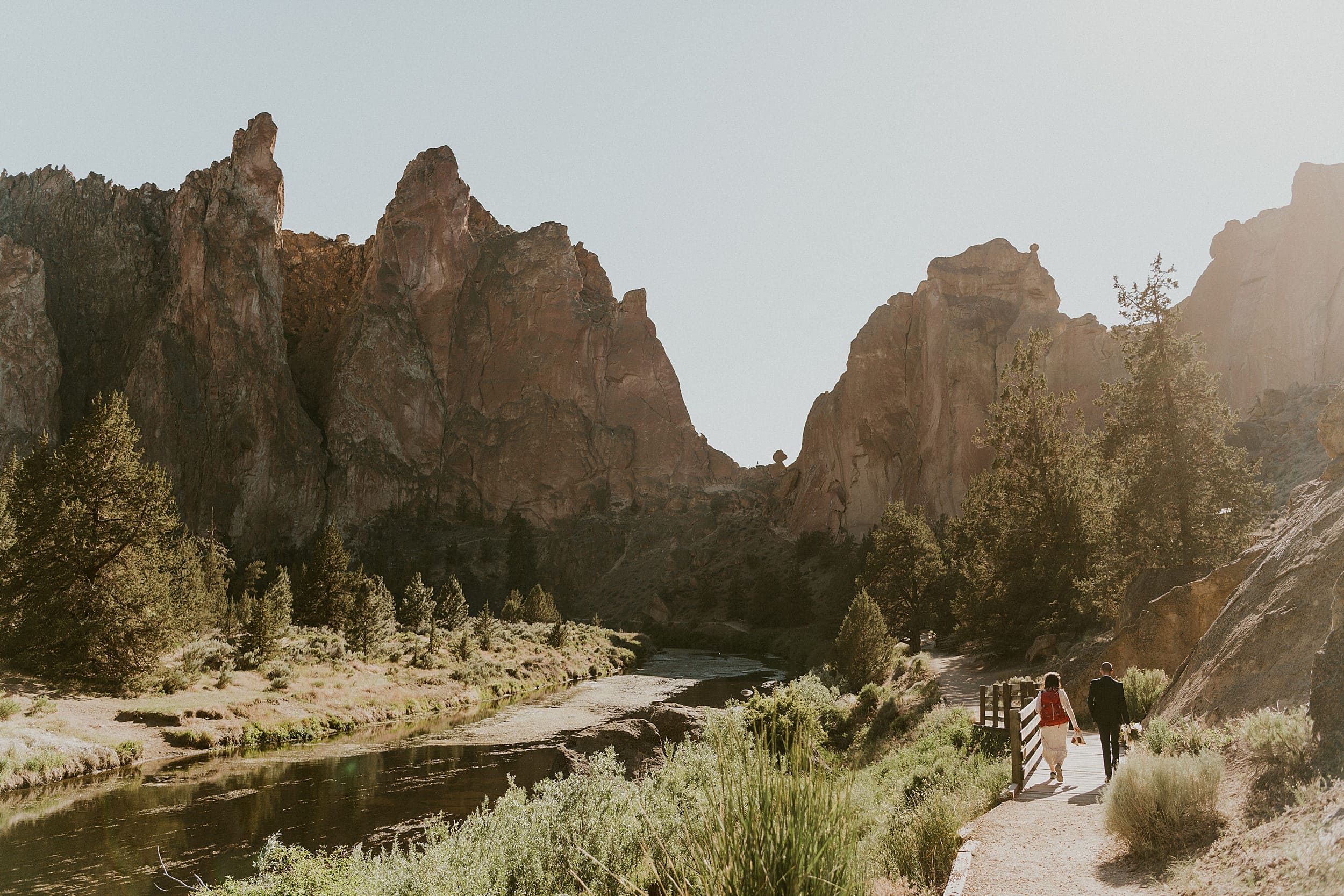 bride and groom hiking together smith rock state park landscape

