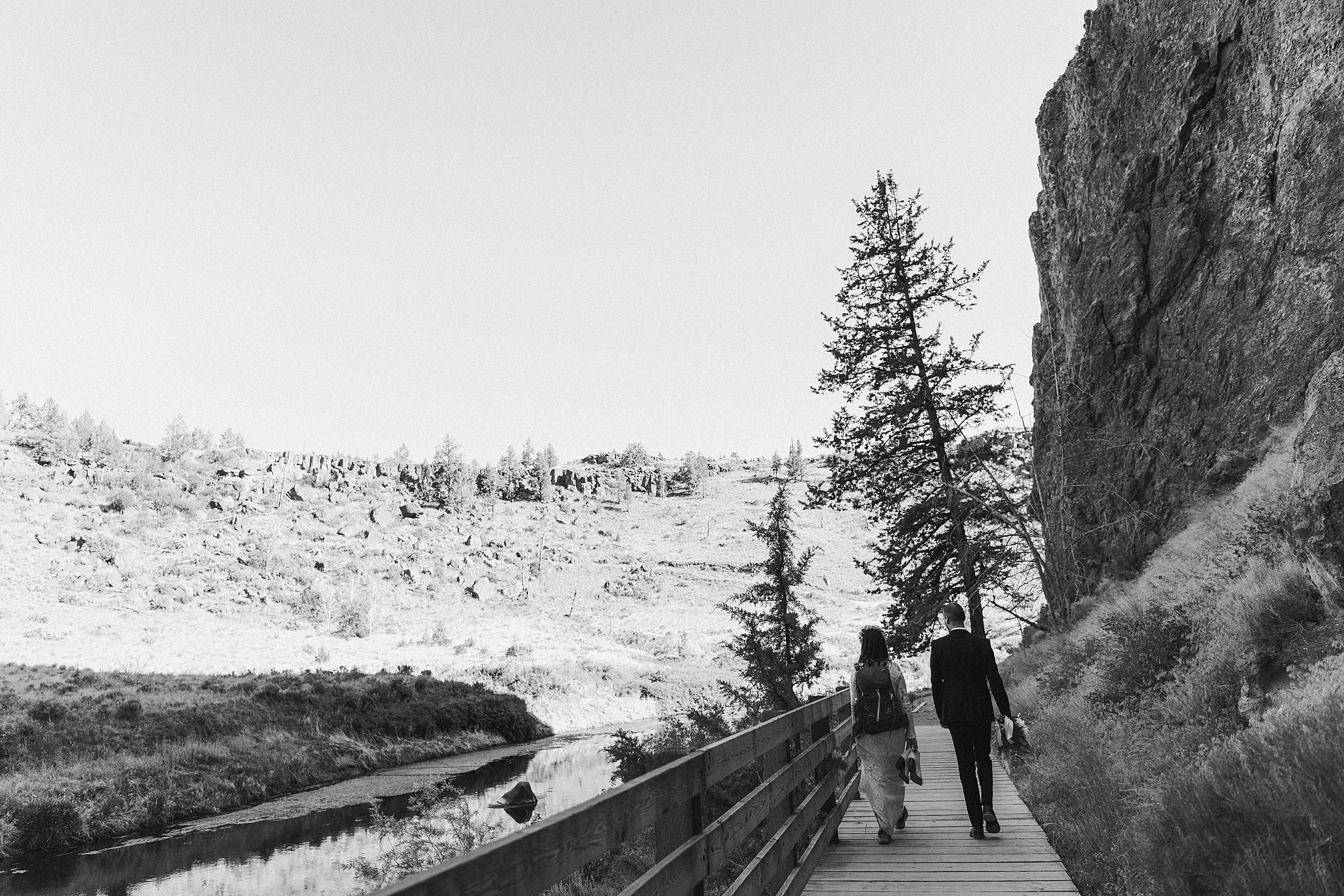 bride and groom hiking smith rock state park landscape
