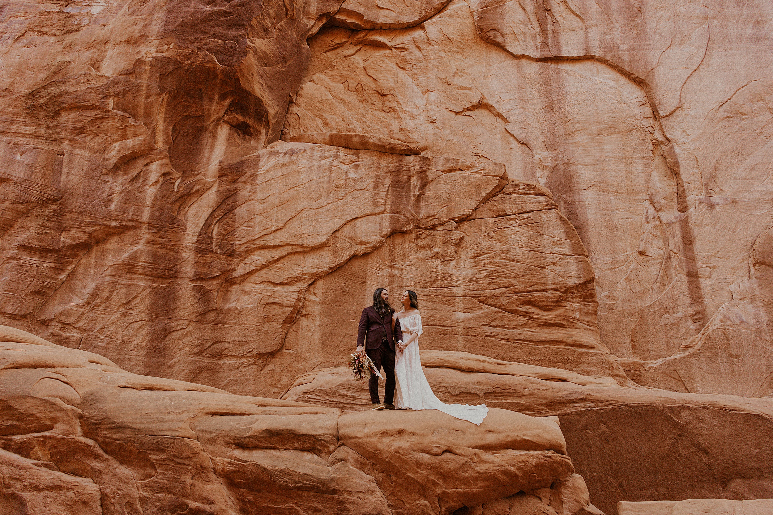 couple standing in red canyon