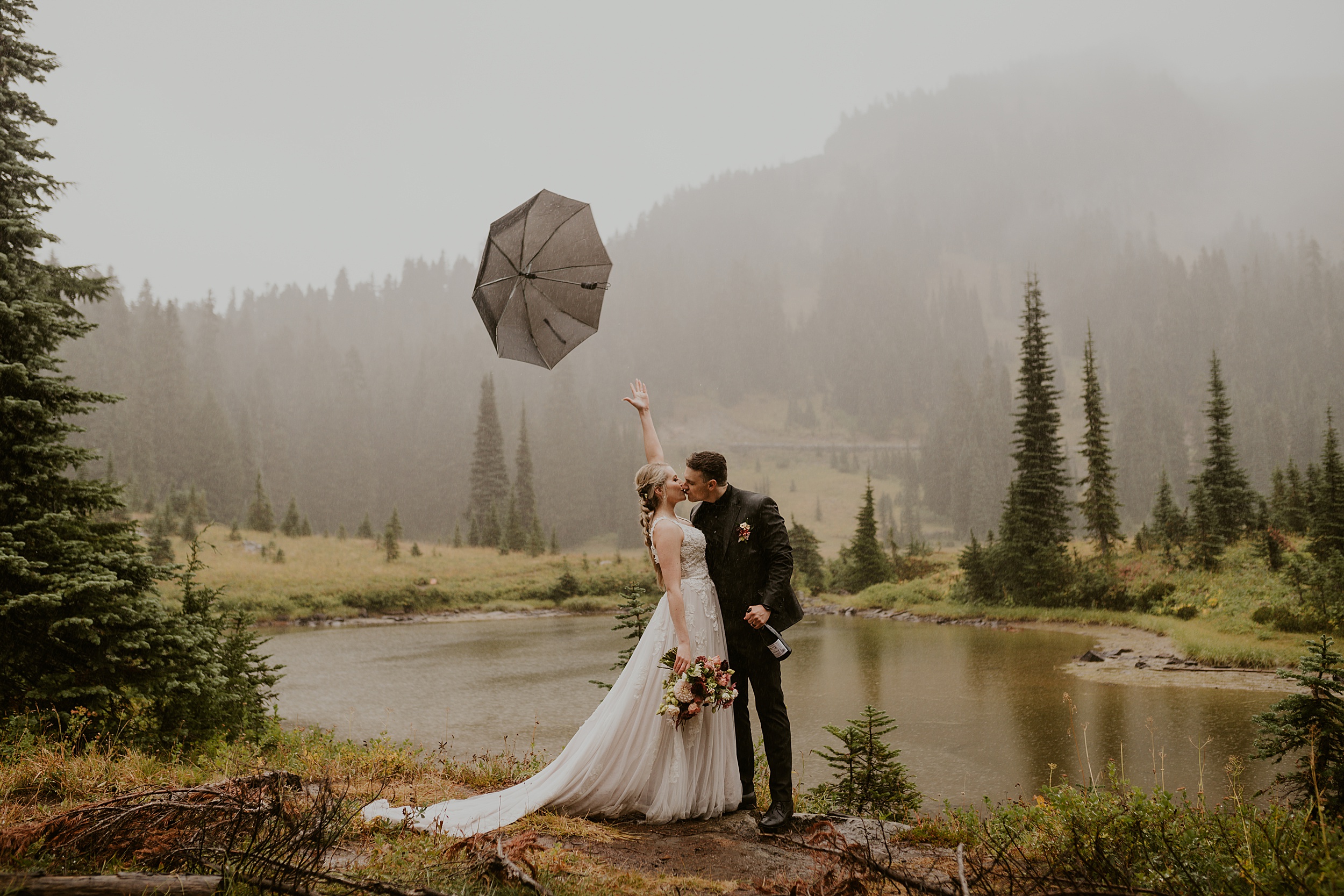 couple kissing under umbrella in the rain