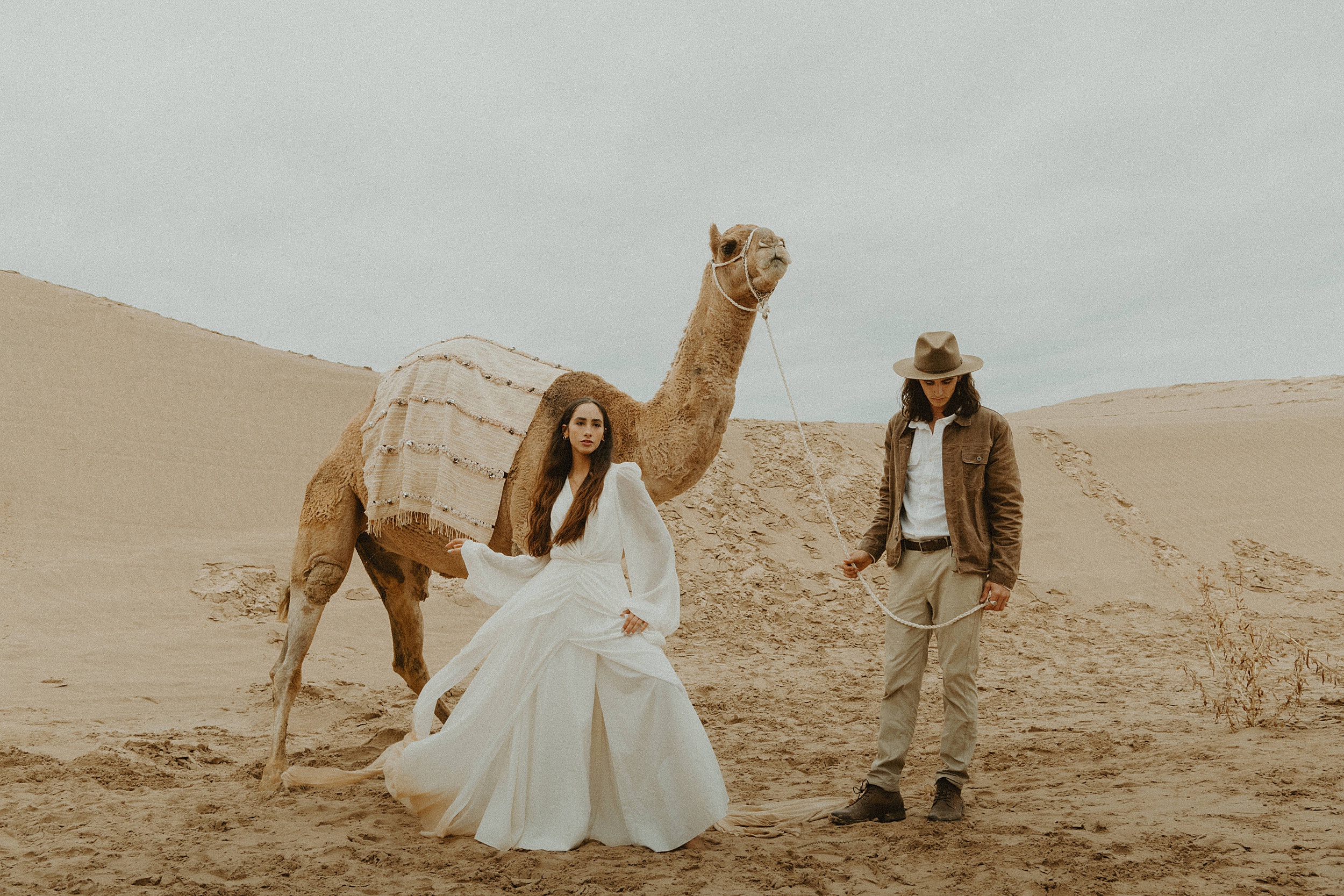 couple walking with camel